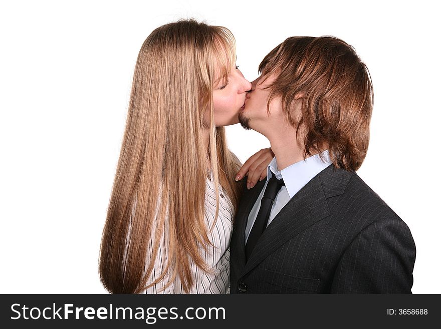 Young kissing couple on a white