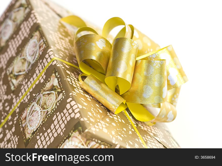 Detail of a gift box with golden ribbon and bow