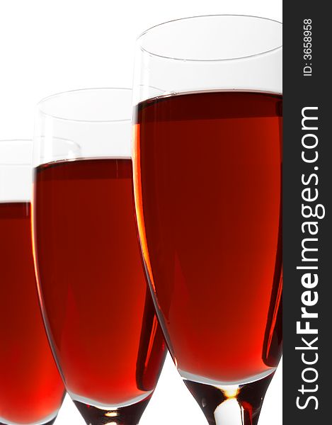 Three glasses with red wine on a white background
