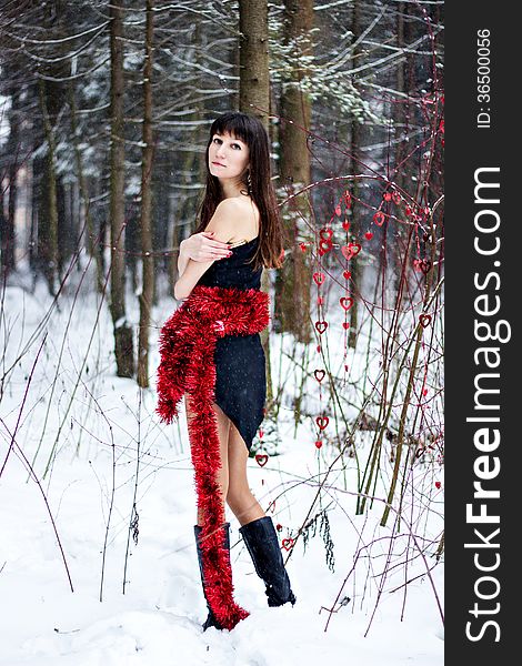 Beautiful Woman With Bright Tinsel In Winter Forest