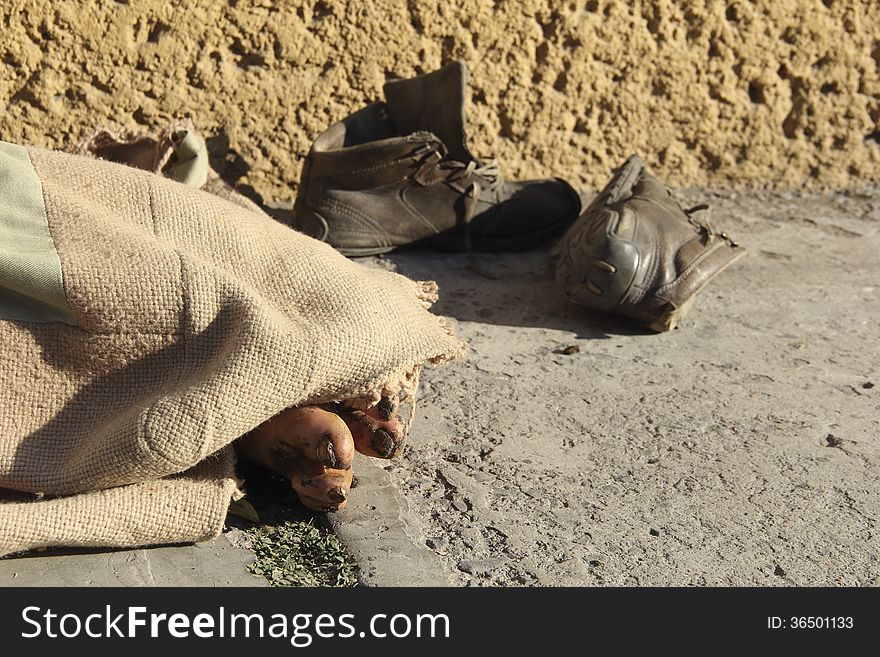 Feet of a destitute person in the street. Feet of a destitute person in the street