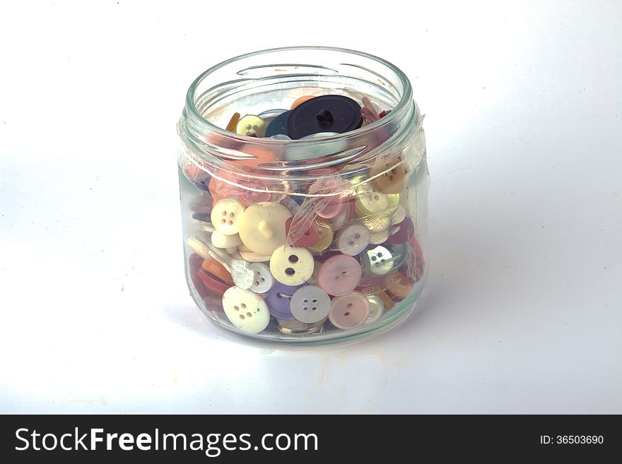 A jar of buttons isolated on a white background.
