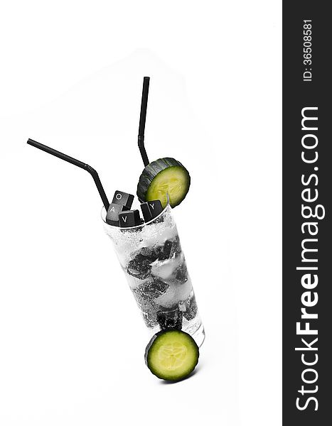 Keyboard and cucumber cocktail on ice rocks against white background