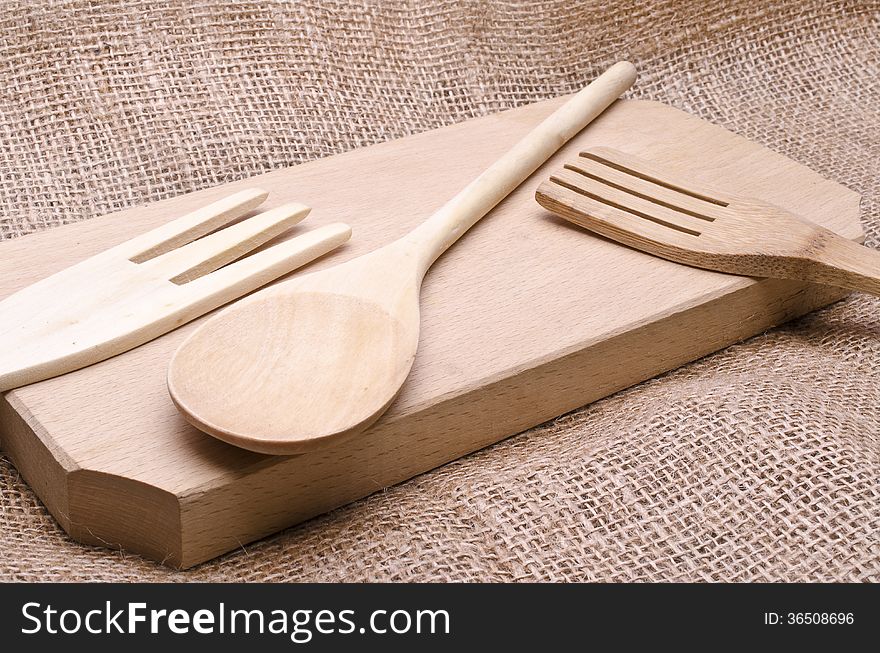 Kitchen wooden tools on a hemp background