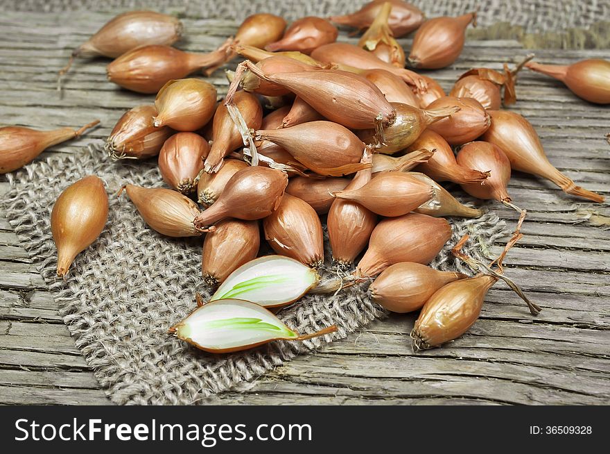 Shallot onions on a wooden and jute background