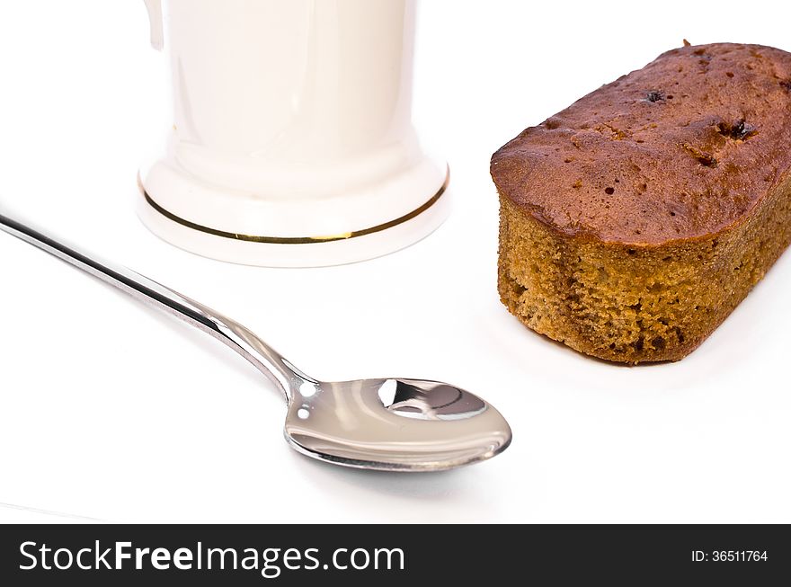 Sweet dessert with spoon and a cup on a white table. Sweet dessert with spoon and a cup on a white table