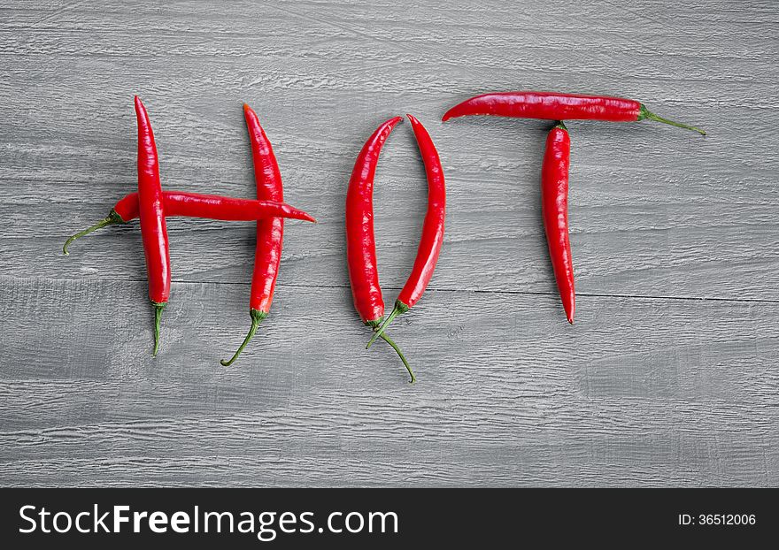 Fresh hot chili pepper on wooden vintage table