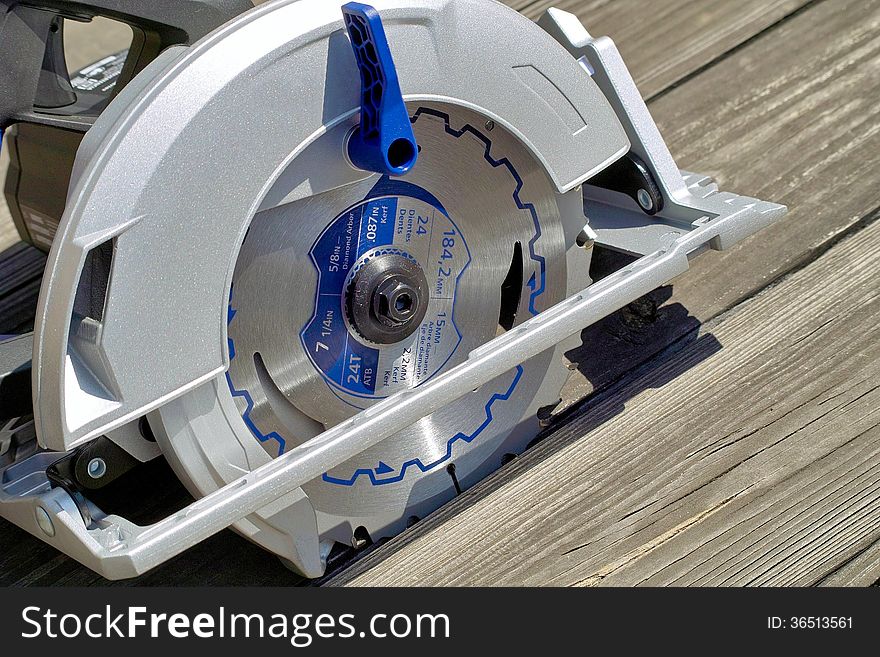 A close up view of a modern power circular saw. A close up view of a modern power circular saw.