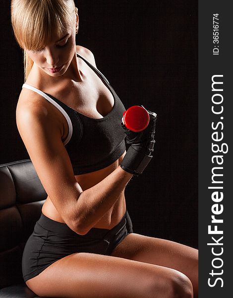 Woman holding red dumbbell