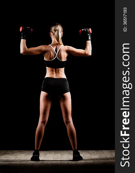 Woman holding red dumbbells