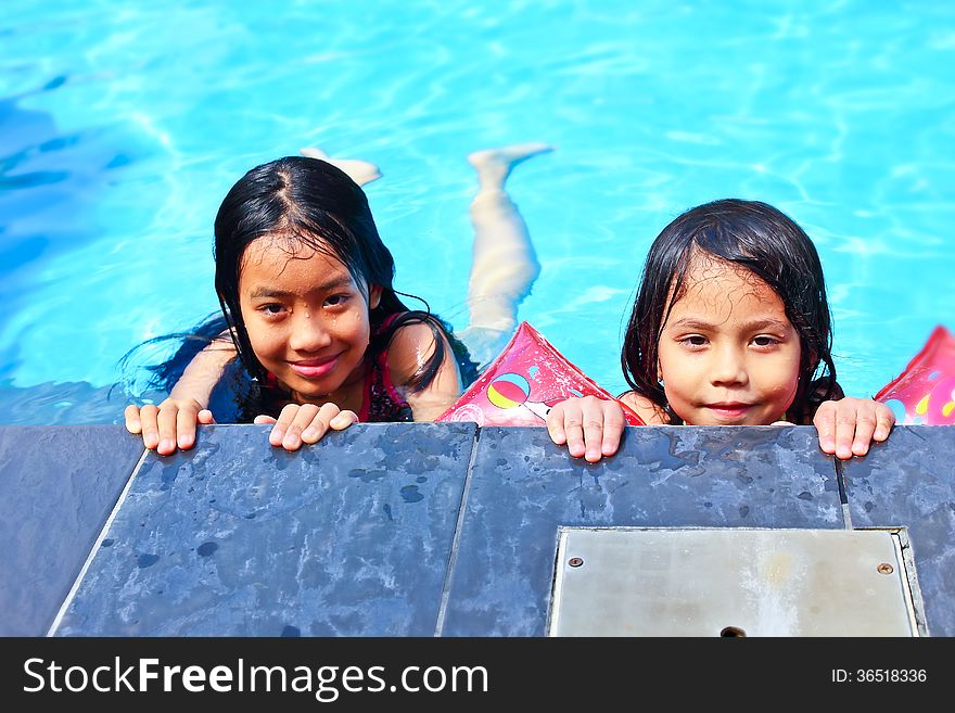 Two girls have fun in the pool. Two girls have fun in the pool