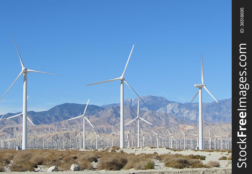 Modern windmills near Palm Springs, California with mountains in background. Modern windmills near Palm Springs, California with mountains in background