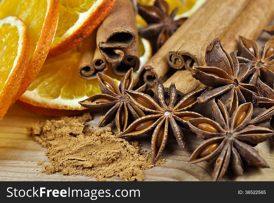 Cinnamon sticks and powder, anise stars and slices of dried orange. Cinnamon sticks and powder, anise stars and slices of dried orange