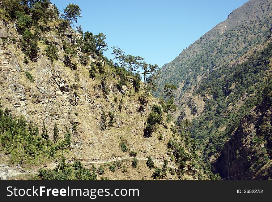 Trail on a steep mountain slope, typical for the route in the Himalayas. Trail on a steep mountain slope, typical for the route in the Himalayas