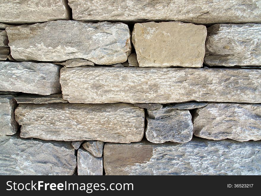 Wall of gray rectangular stones. Wall of gray rectangular stones