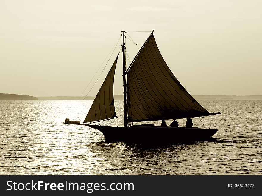 A sailboat on the lake with sun setting. A sailboat on the lake with sun setting