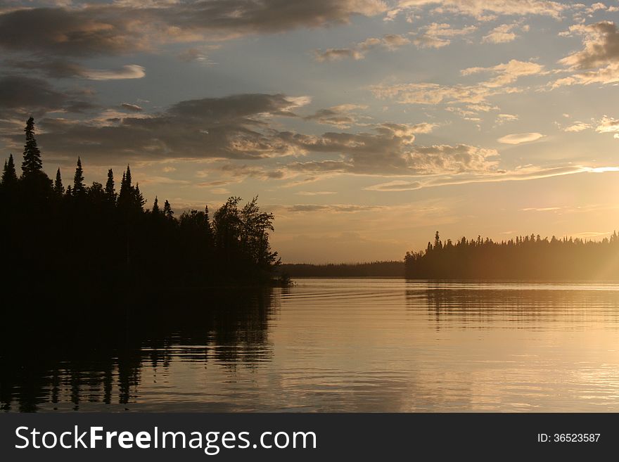 Sun setting over a lake in northern Canada. Sun setting over a lake in northern Canada