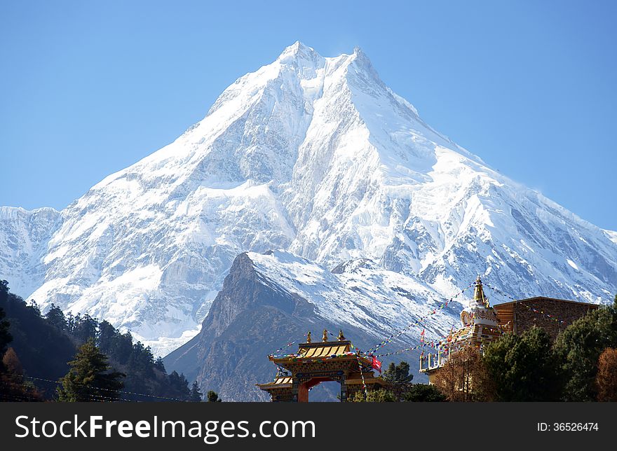 Snow peak, and the Buddhist monastery on its background