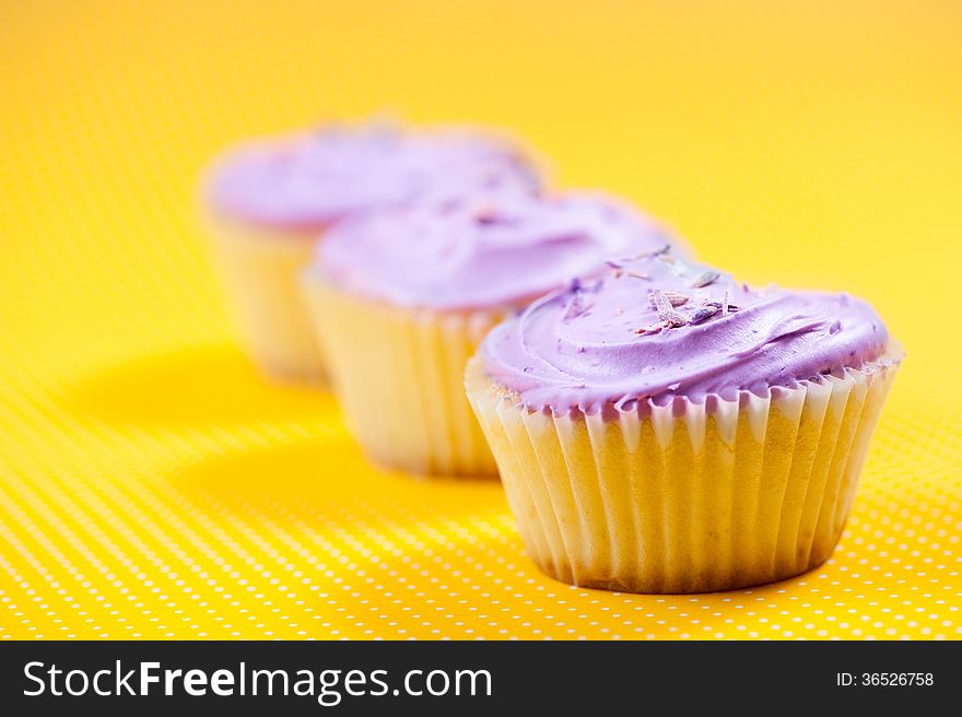 Muffin with vanilla filling against yellow background