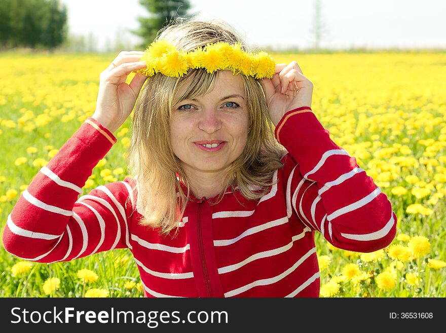 A smiling woman with a dandelion Crown. A smiling woman with a dandelion Crown