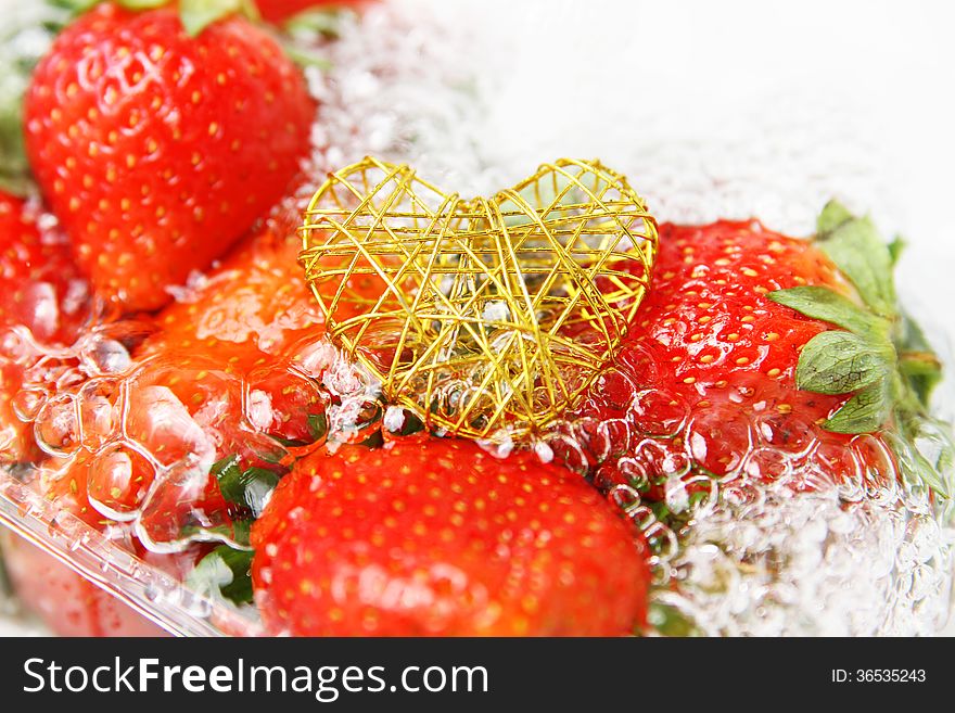 Fresh strawberries with water bubbles on white