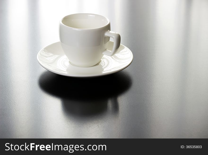 Coffee white cup and plate on black table with nice reflection. Coffee white cup and plate on black table with nice reflection