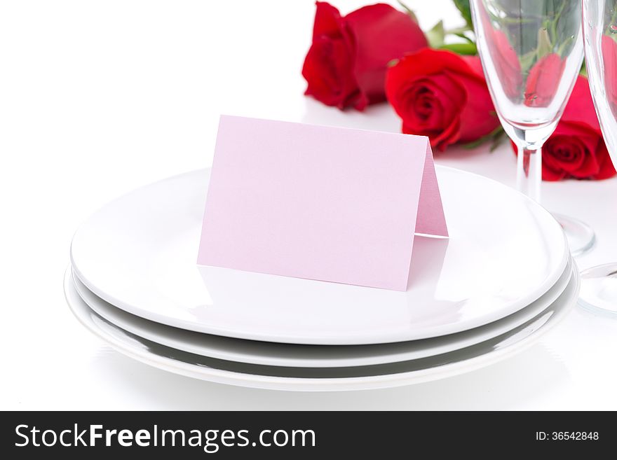 Card for congratulation on a plate, roses and glasses for Valentine's Day, isolated