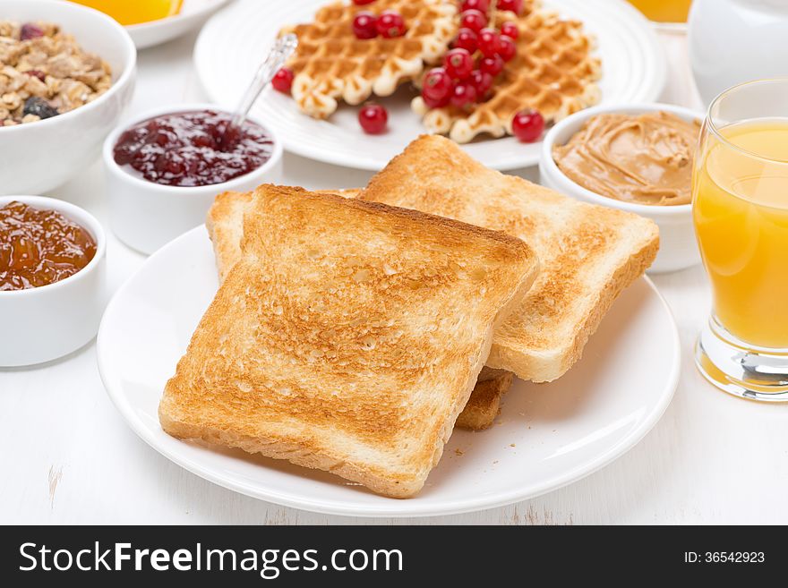 Continental breakfast - toast, jam, peanut butter, juice, horizontal