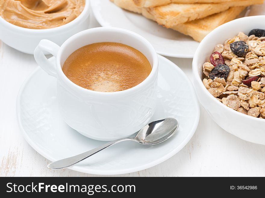 Freshly brewed espresso and muesli for breakfast, close-up
