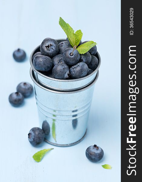 Metal bucket with fresh blueberries, close-up