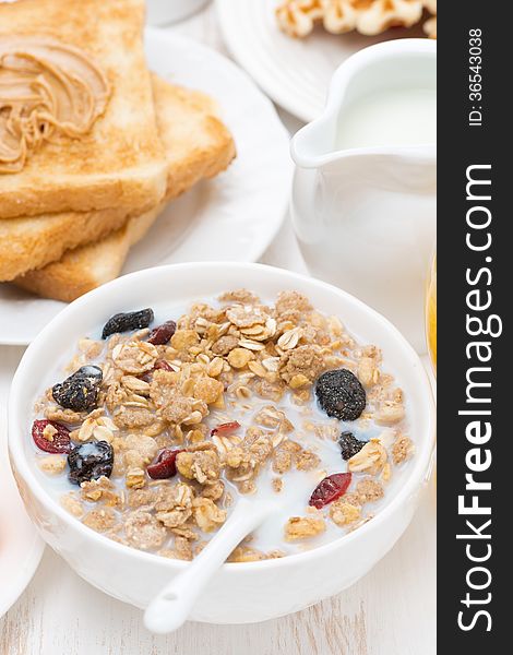 Muesli with milk, toast with peanut butter for breakfast, close-up