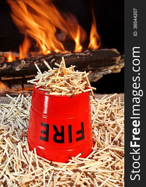 Inverted fire-bucket on a pile of matches against the flames. Inverted fire-bucket on a pile of matches against the flames