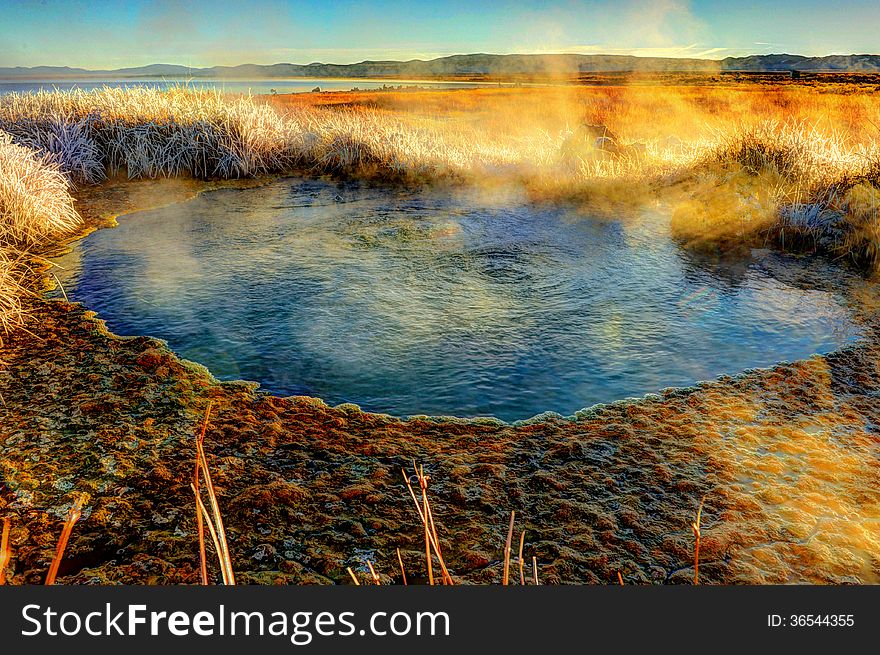 A Mono Lake geothermal pool steams at sunrise