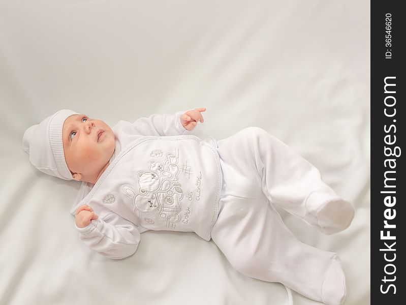 Babe in white a cap lies on white background. Babe in white a cap lies on white background