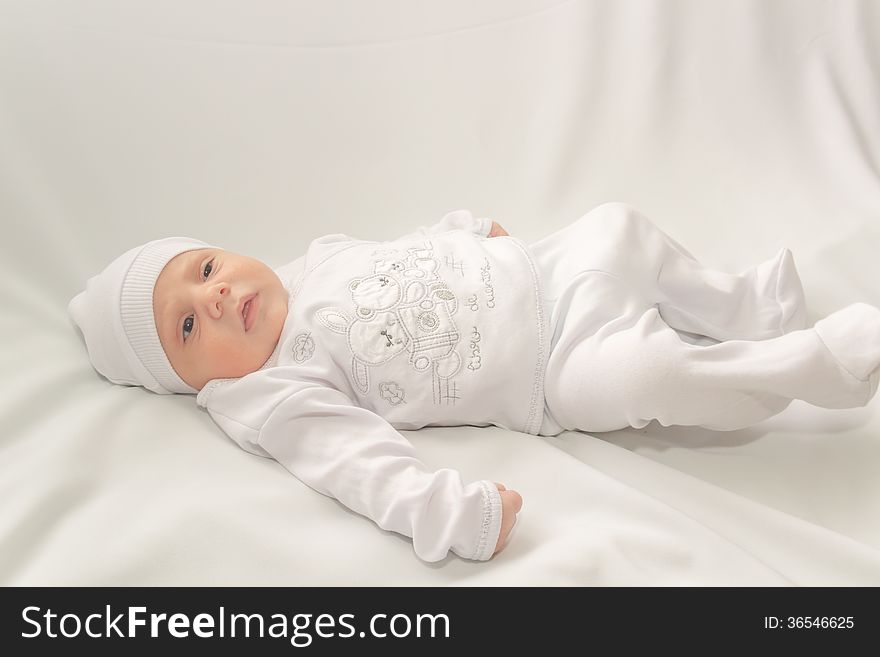 Babe in white a cap lies on white background. Babe in white a cap lies on white background