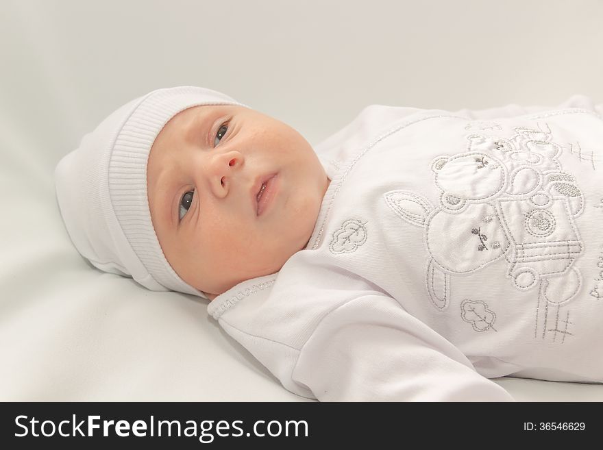 Babe in white a cap lies on white background. Babe in white a cap lies on white background