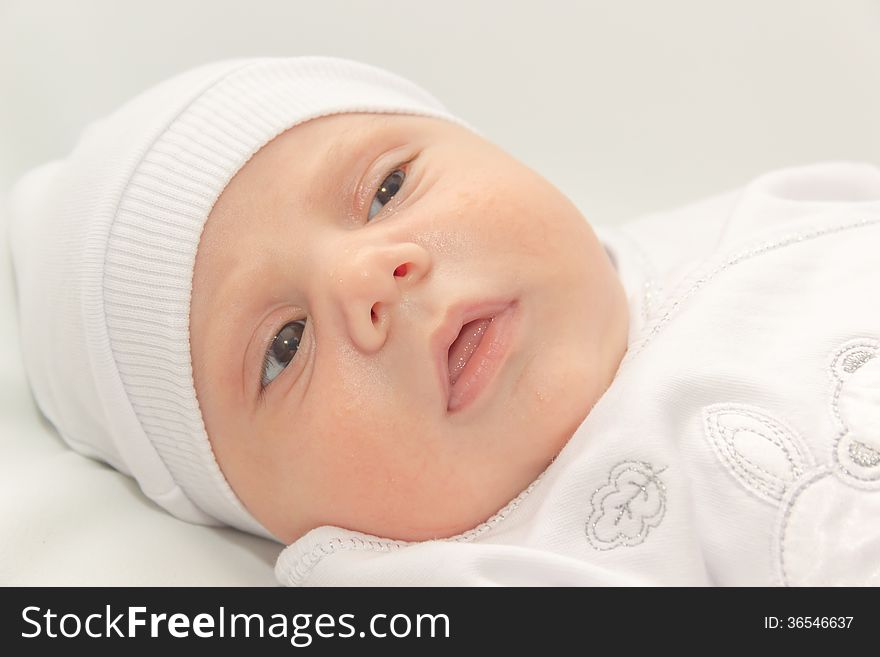 Baby in white a cap