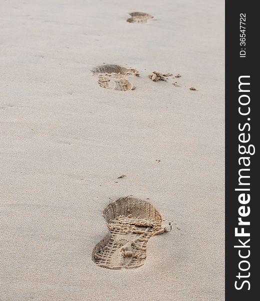 Foot Prints On A Sandy Beach