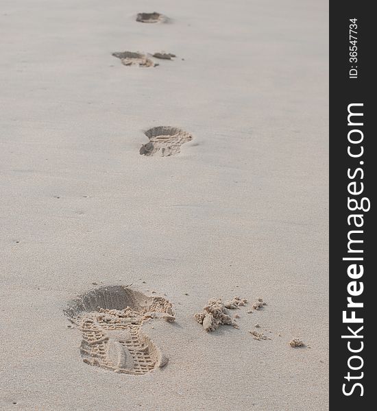 Footprint in the sand at a beach in the evening light. Footprint in the sand at a beach in the evening light.