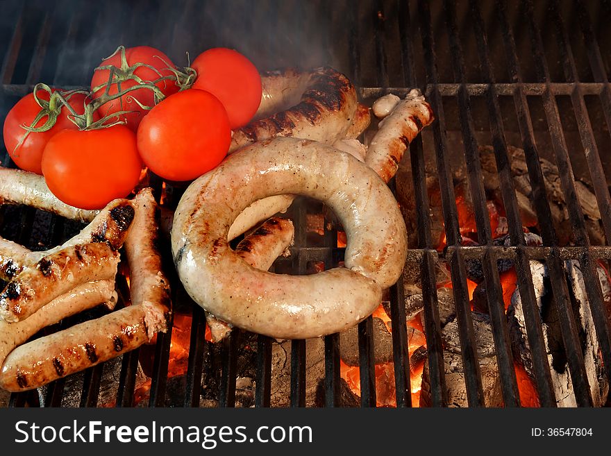 Grilled Sausages and tomato on the BBQ XXXL. Grilled Sausages and tomato on the BBQ XXXL