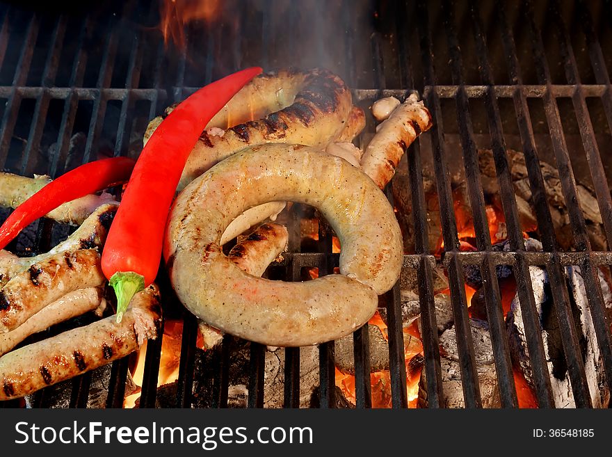 Grilled Sausages and Red Chili Pepper on the BBQ XXXL. Grilled Sausages and Red Chili Pepper on the BBQ XXXL