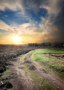 Country Road Through The Plowed Field Royalty Free Stock Photos Country Road Through The Plowed Field Royalty Free Stock Photos