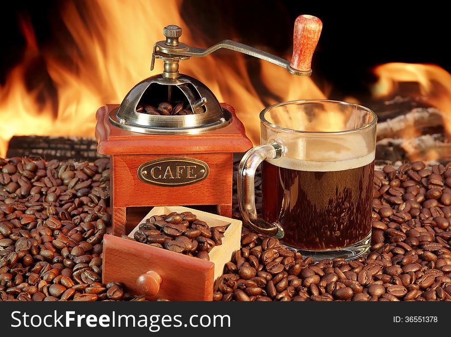 Coffee Mug and Old Coffee Grinder at the fireplace. Coffee Mug and Old Coffee Grinder at the fireplace