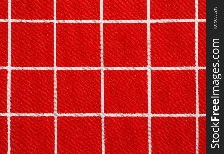 Red and white gingham tablecloth pattern, close-up.