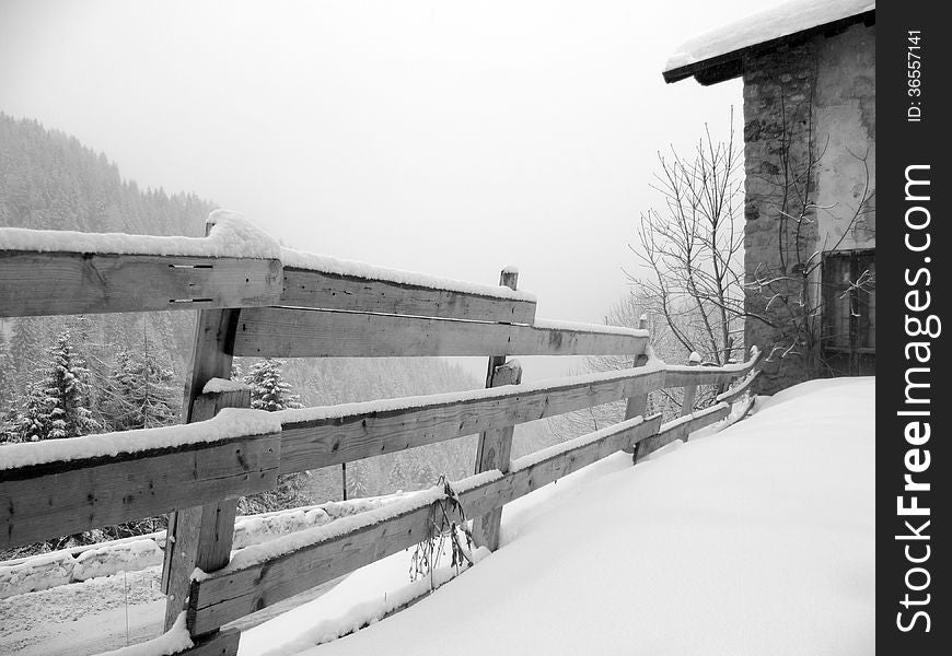 Wooden fence in winter, black and white photo. Wooden fence in winter, black and white photo