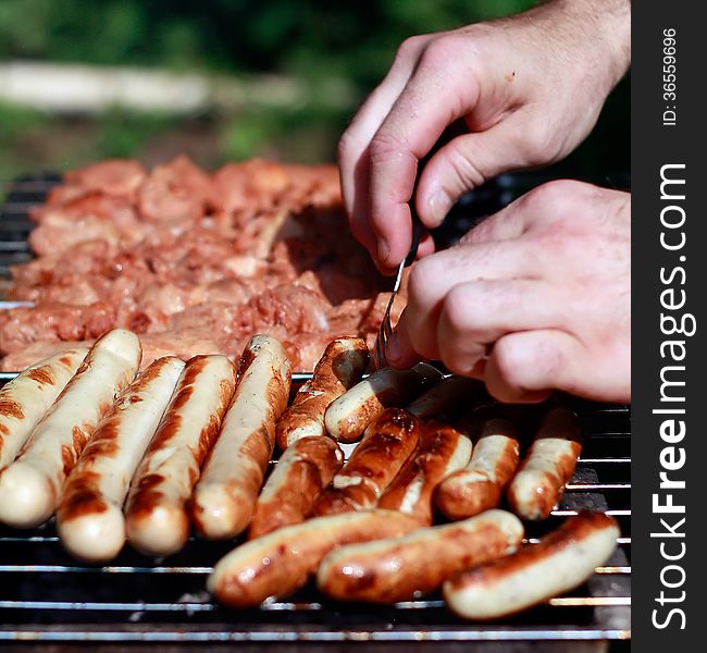 Meat and sausages on the grill background. Meat and sausages on the grill background