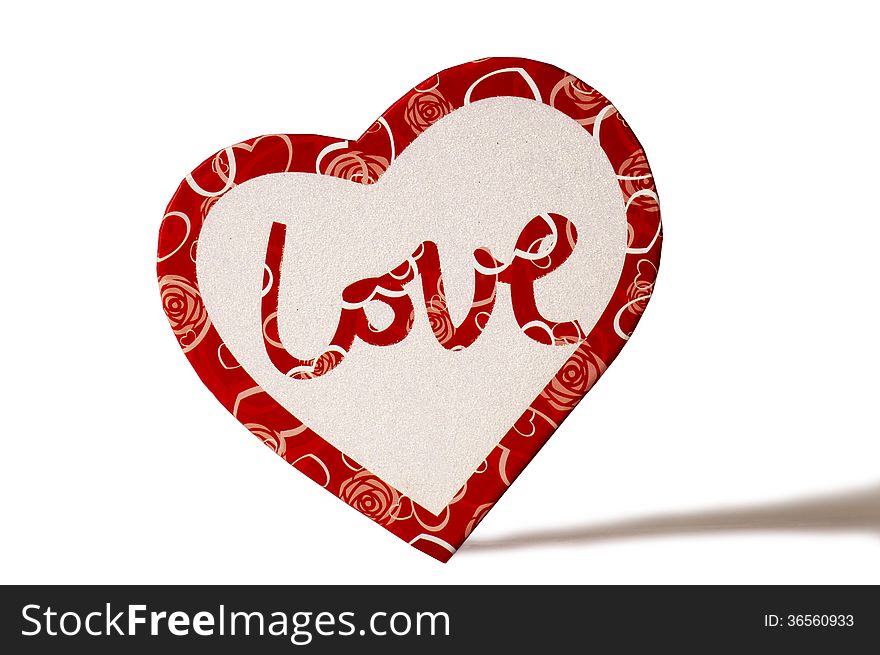 The word Love written on the top of a heart shaped box and shot on white background. The word Love written on the top of a heart shaped box and shot on white background.