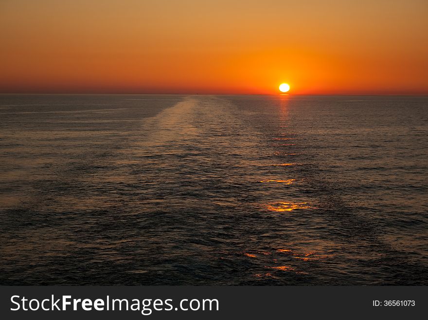 Sunset in the sea and a trace from the ship. Sunset in the sea and a trace from the ship