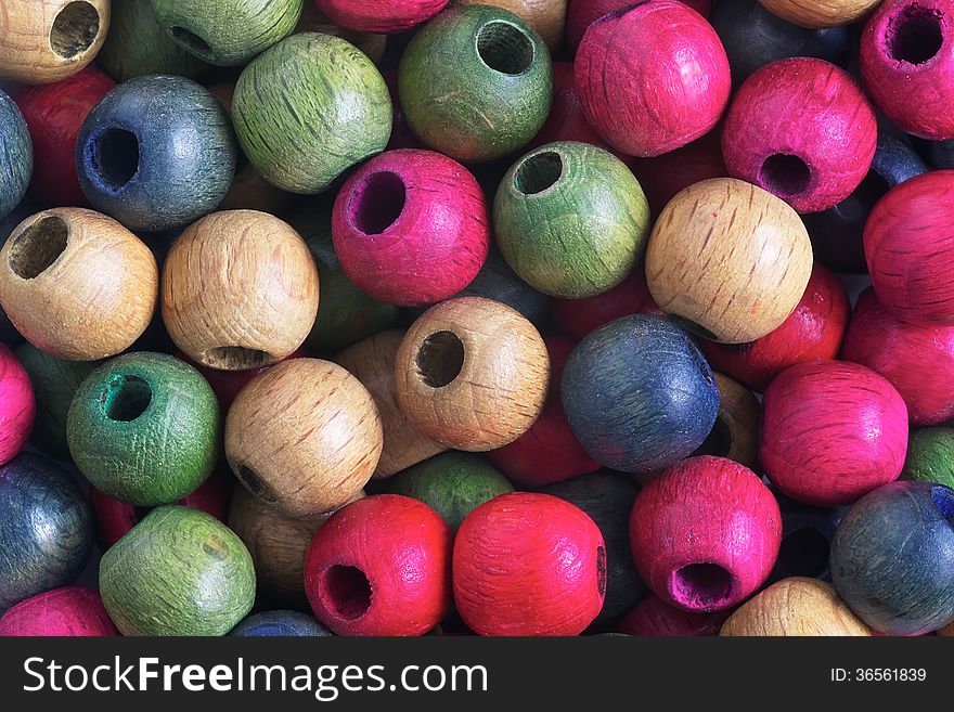 Detail different colored wooden beads. Detail different colored wooden beads