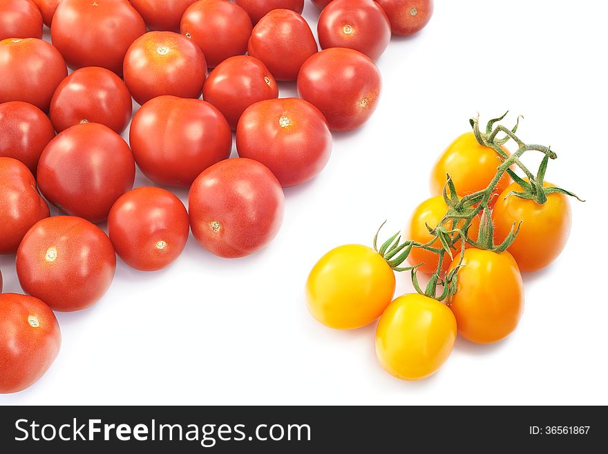 Yellow and red tomatoes on a white background